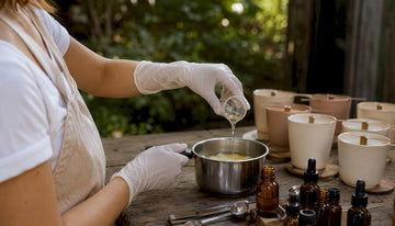 Pouring fragrance oil into candle wax