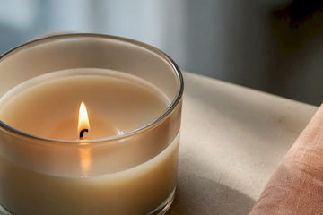 Clean candle flame beside soot-free glass rim