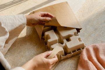 Hands examining biodegradable packaging materials
