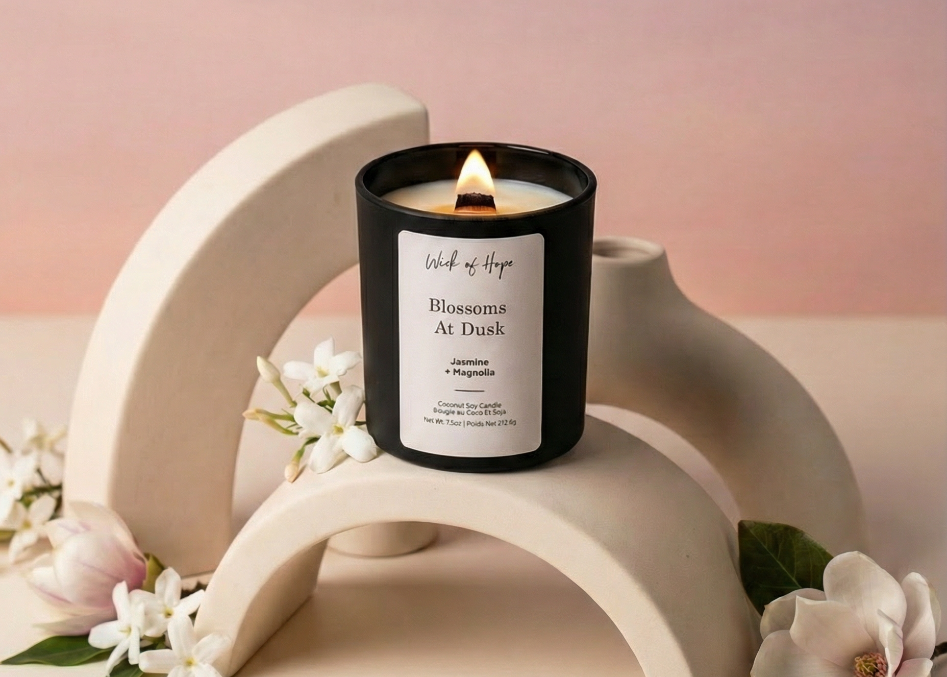 Wick of Hope candle, lit, with Blossoms at Dusk styling
